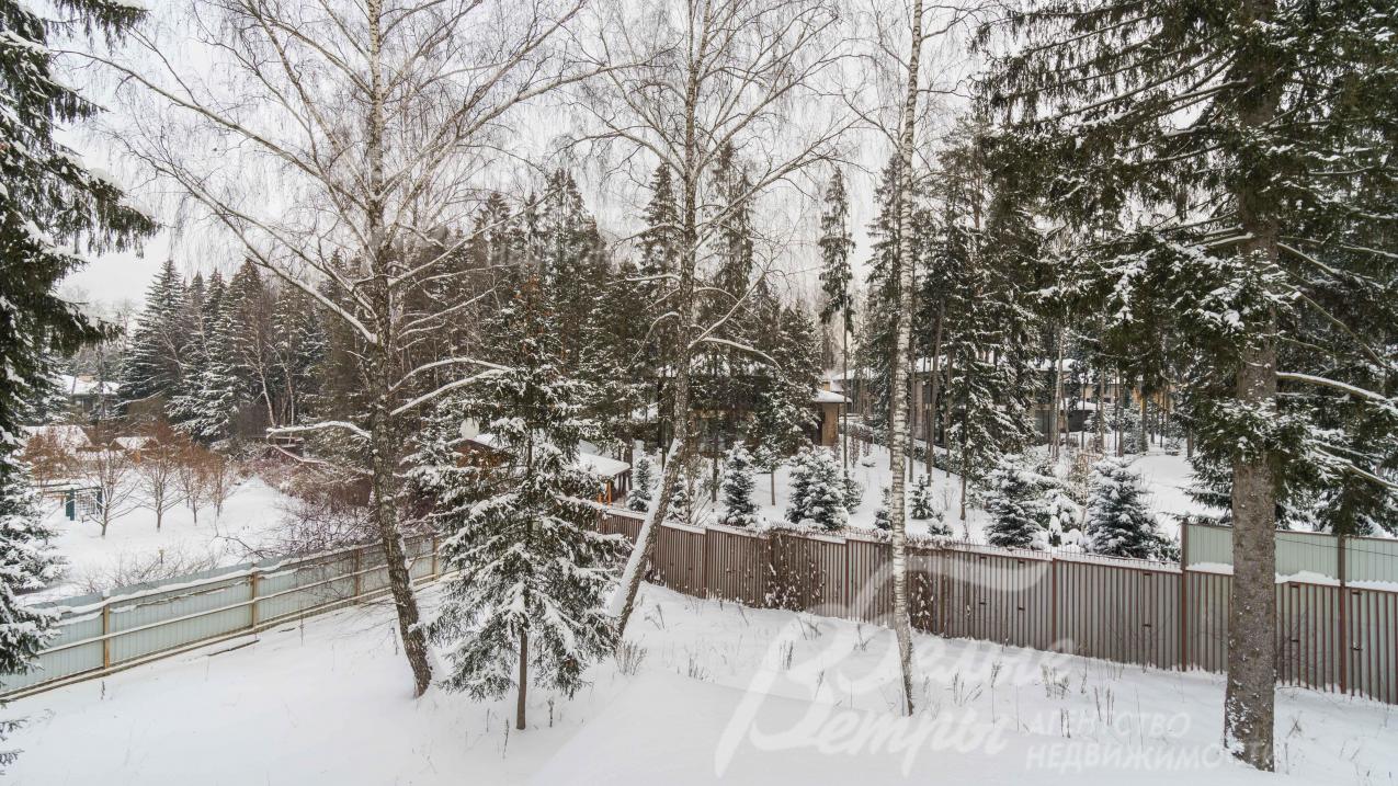 На участке высажен газон, растут взрослые деревья и кустарники