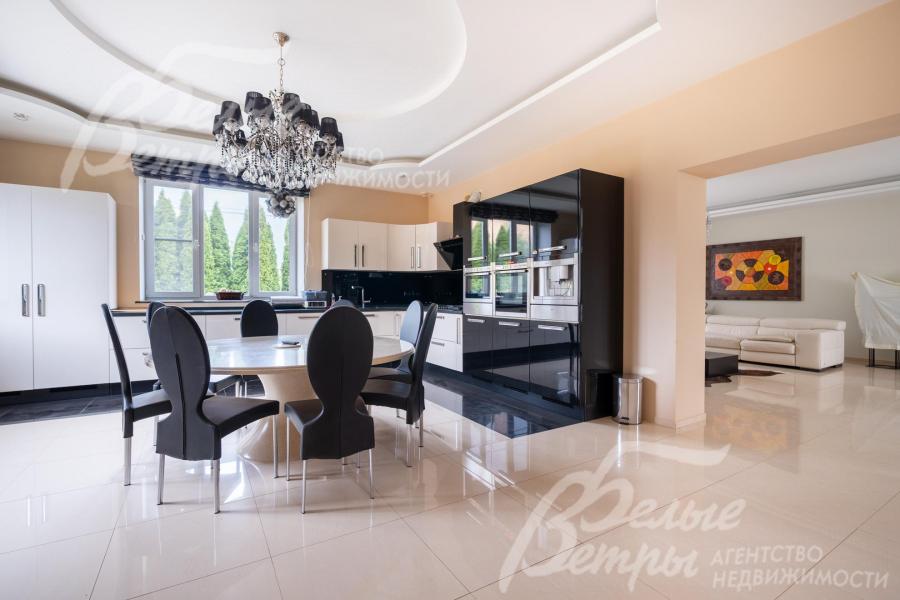 В кухне-столовой - обеденная группа с большим круглым столом